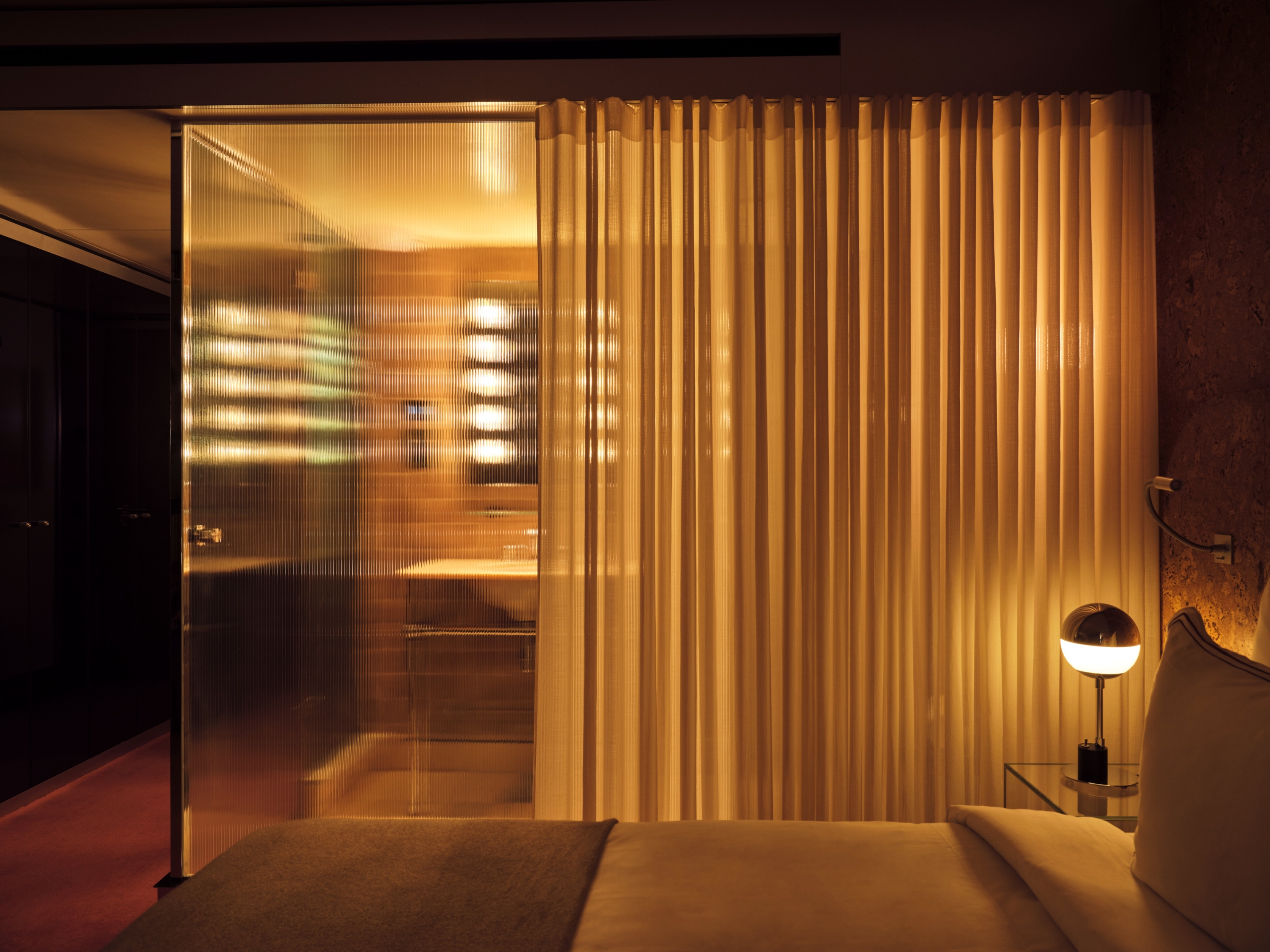 Bus Palladium Hotel room interior with ribbed glass partition and warm curtain lighting designed by Studio KO