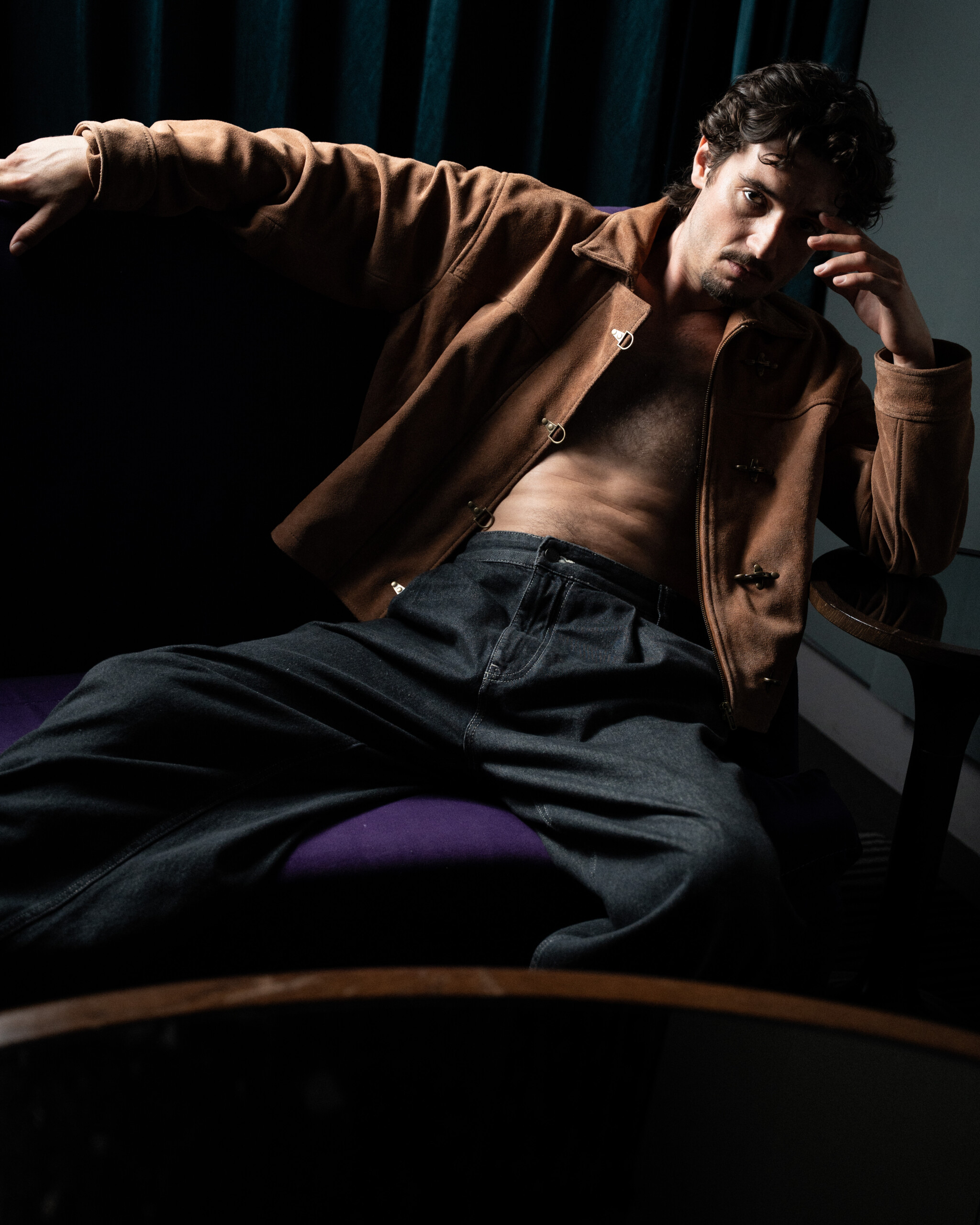 Jack Brett Anderson in a Barney's suede jacket, seated